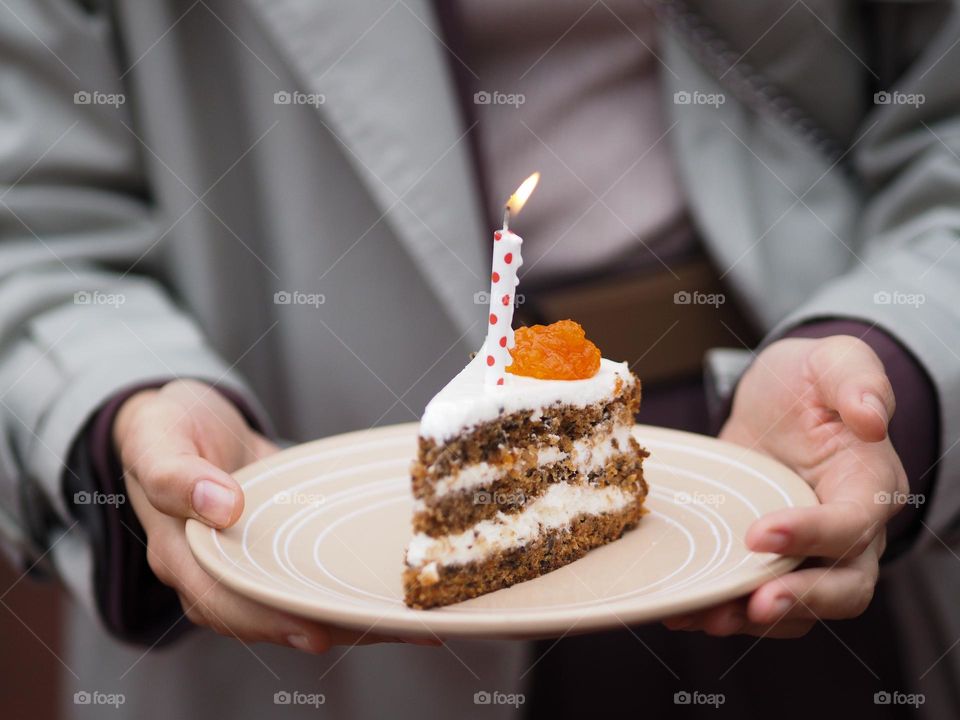 Female holding plate with birthday cake