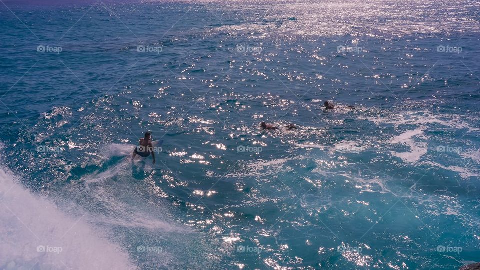 Surfer on the wave from above