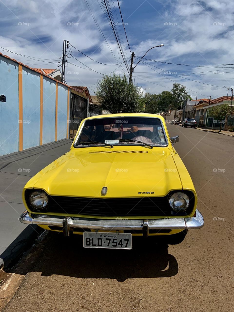 Yellow vintage car parking in the street 