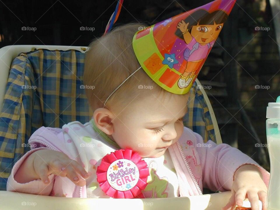 Little baby wearing birthday hat