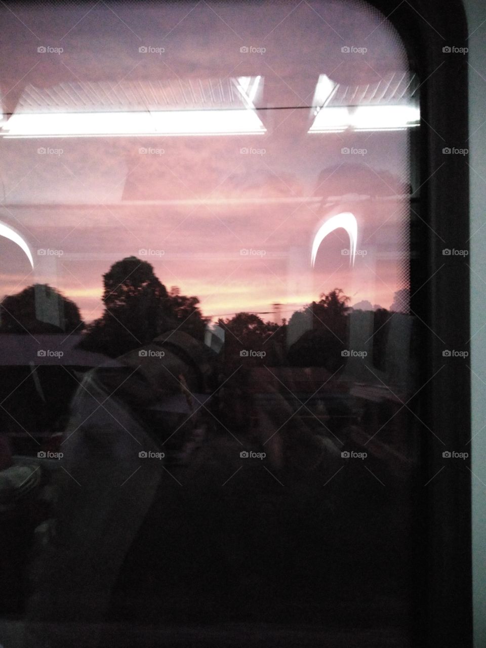 The beautiful color of the sky captured from inside a moving train.