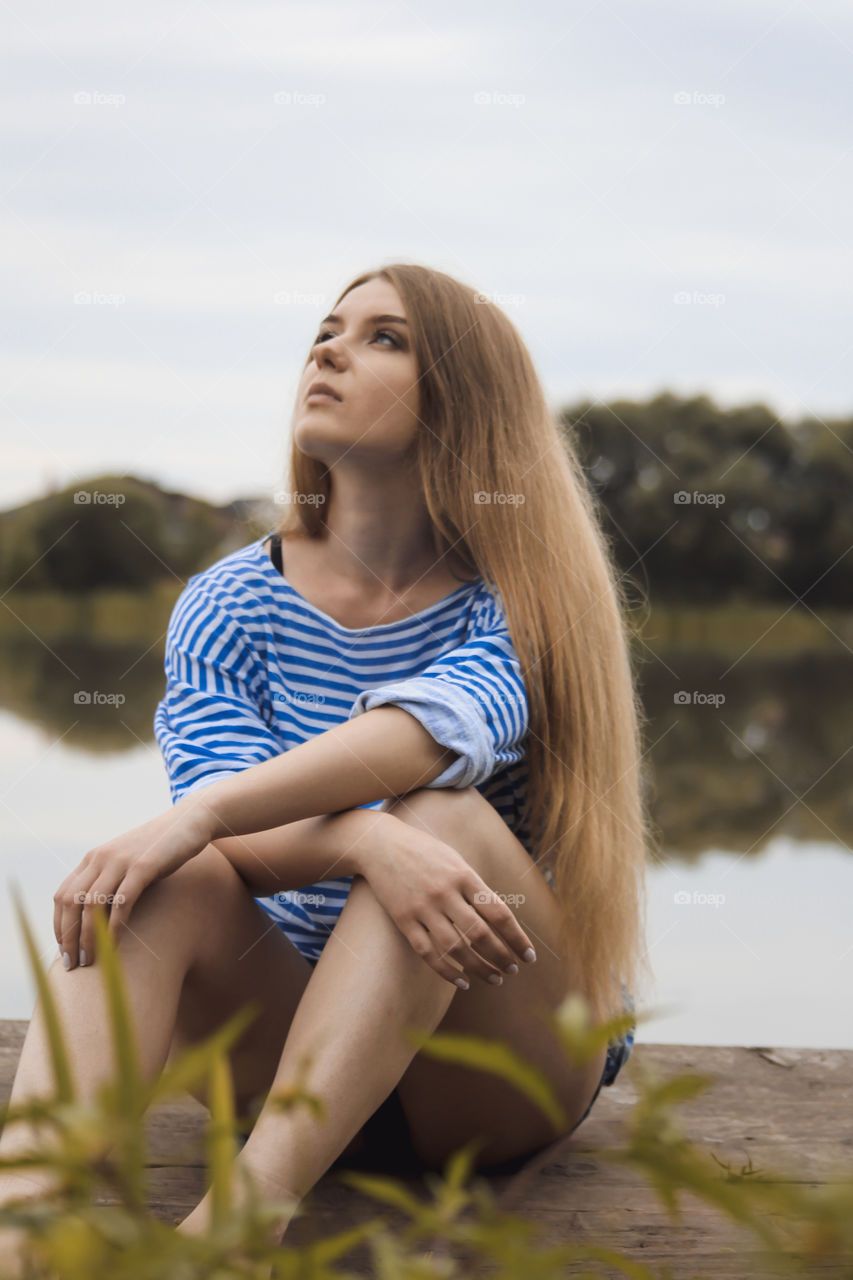 Close-up of blonde woman looking up