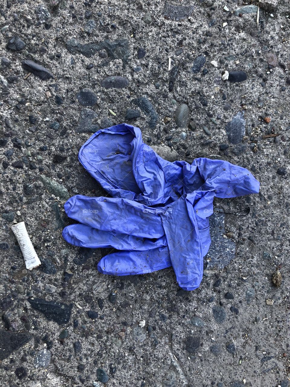 dirty surgical gloves discarded on the street floor, dirty public space,