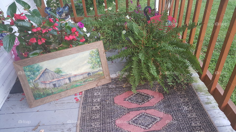 My Front Porch in Indiana. My Roommates late husband painted and made that picture. So beautiful. Persian Rug to go with it. Ferns. Hanging baskets.