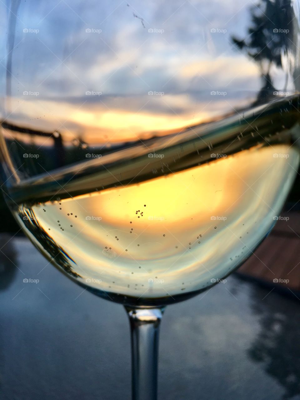 A glass of white wine at sunset 