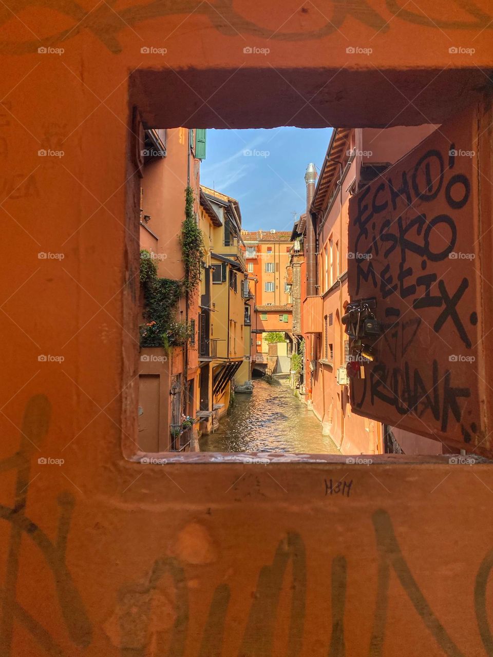 Window above the river, Bologna, Italy