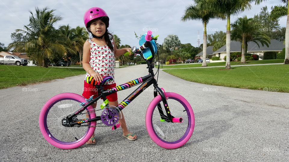 Portrait of a girl standing with her bicycle