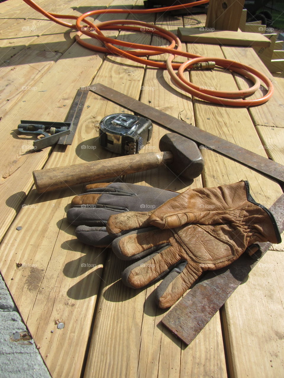 Close-up of work tools on wooden plank