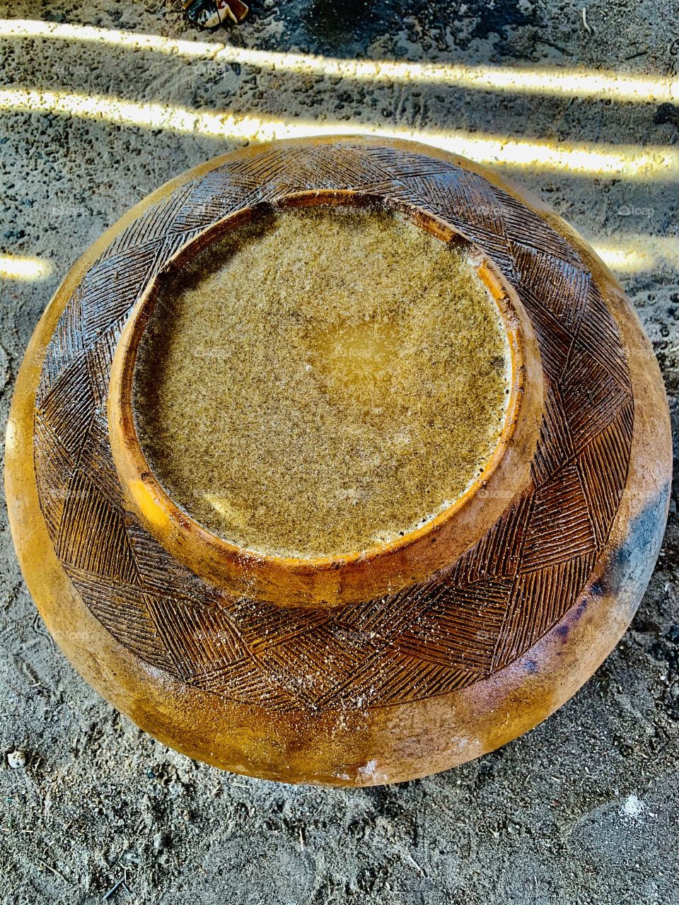 A traditional ceramic bowl holding a traditional brewed beverage. One the ovawambo delicious and respected drink.