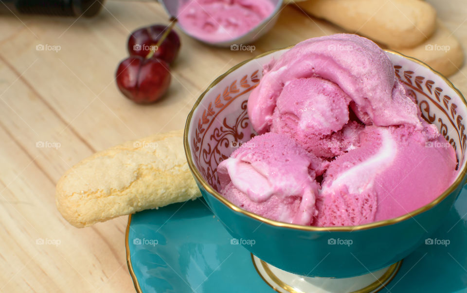 Pink ice cream sorbet scoops with vanilla swirl