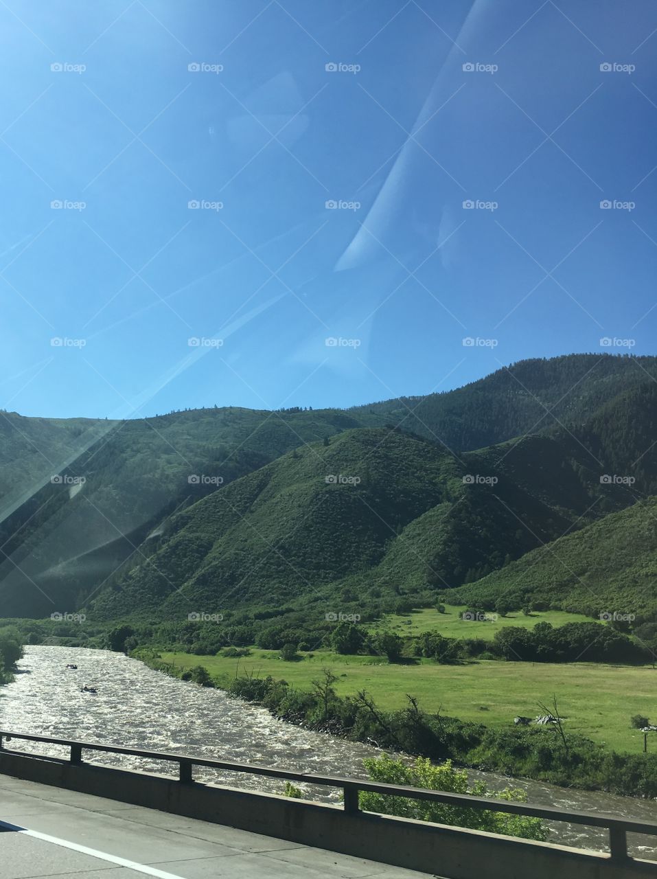 A Colorado morning, in early July. Beautiful blue sky, water rushing down the mountains, and green along the Highway. 