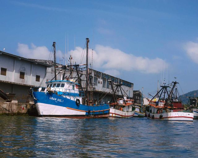 Fishing Boats and ships at Santo's Harbour. Beautiful blue scene. Ocean and sea.