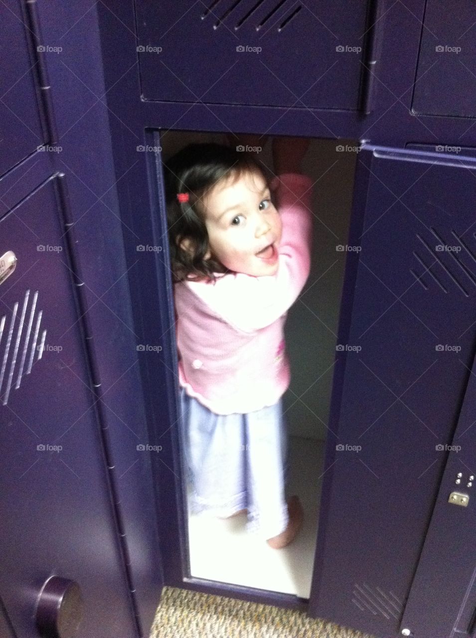 Girl in locker. Little girl inside locker