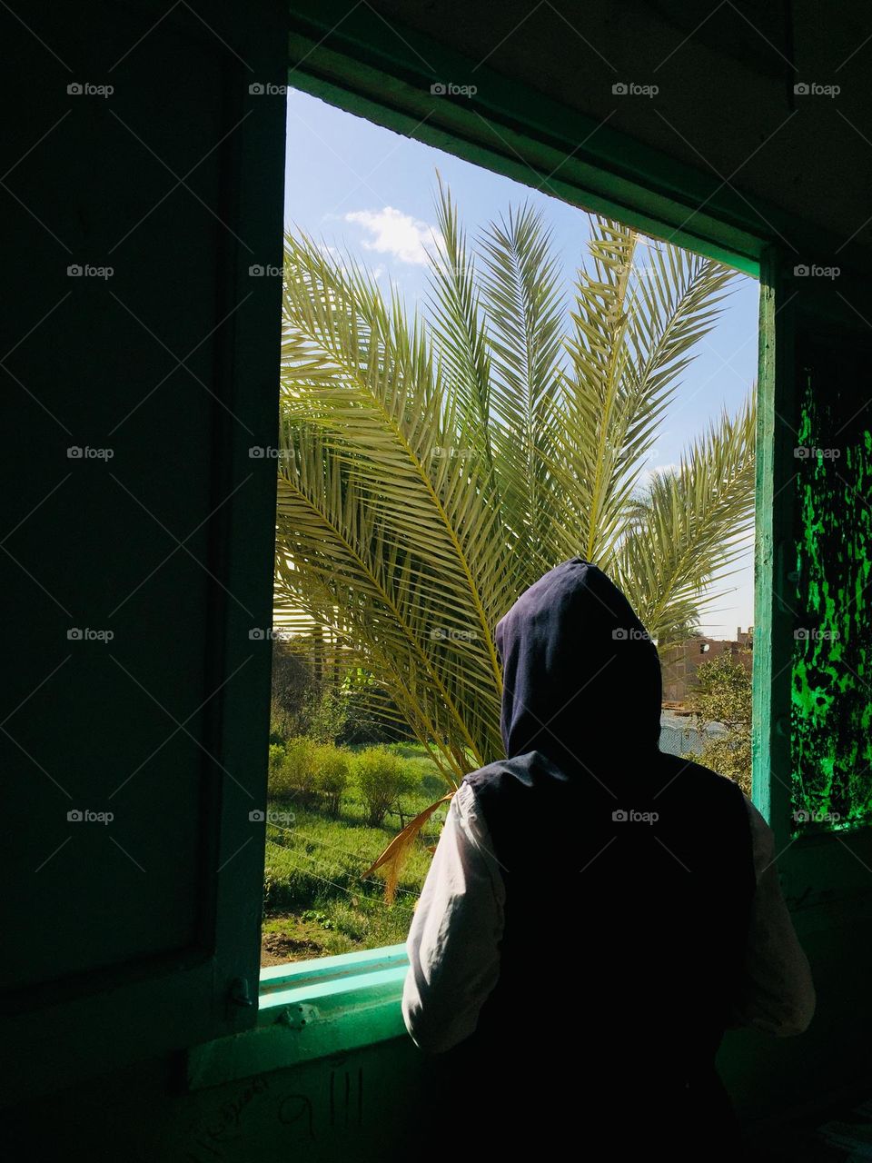 A girl is looking from a window