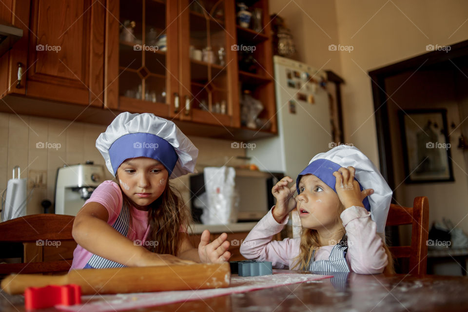 Little sisters cooking the biscuits 