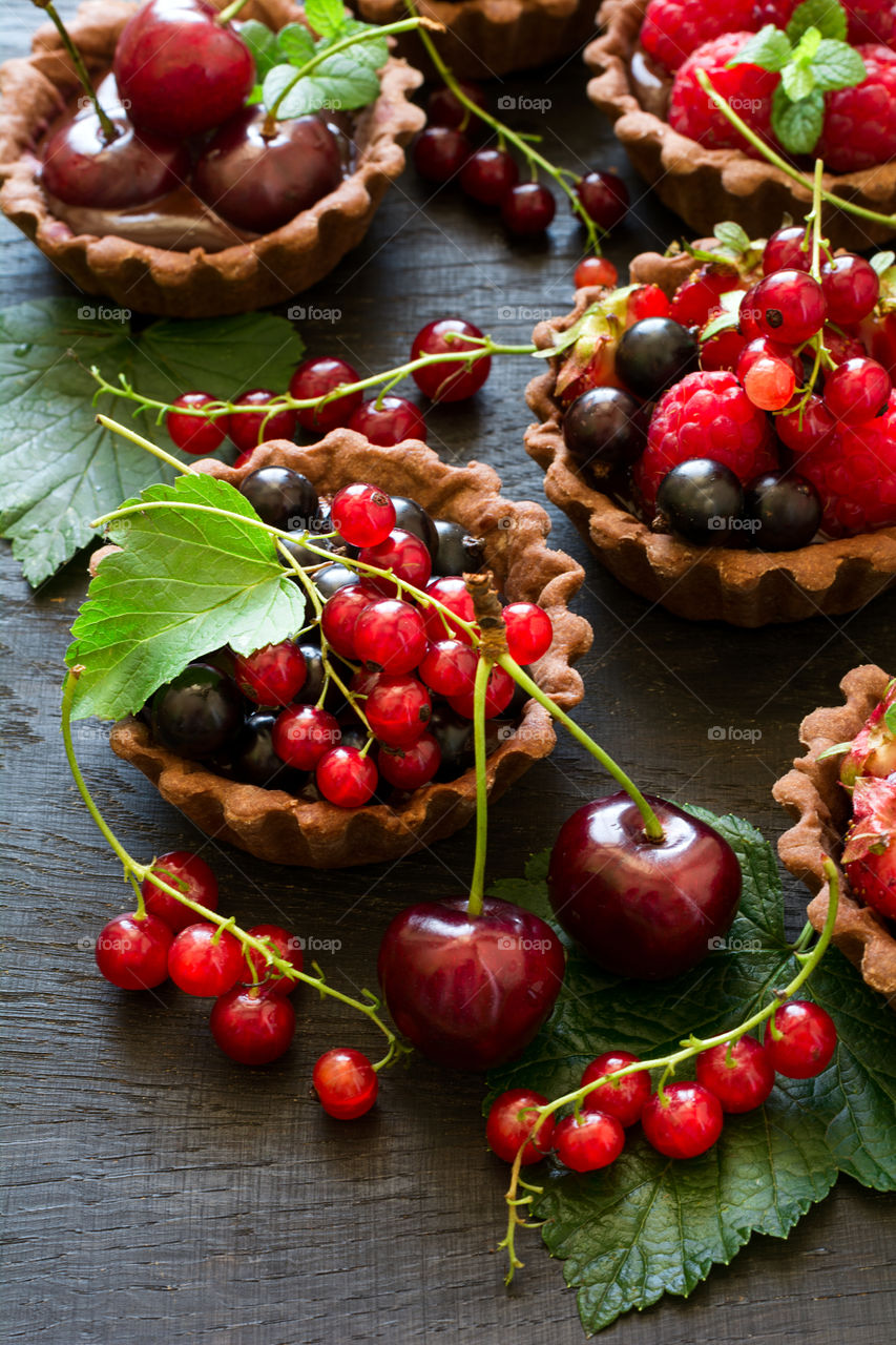 Homemade chocolate mini tarts with berries