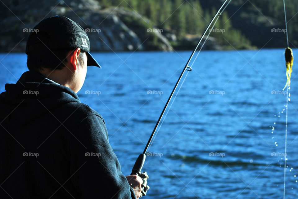 man fishing in lake