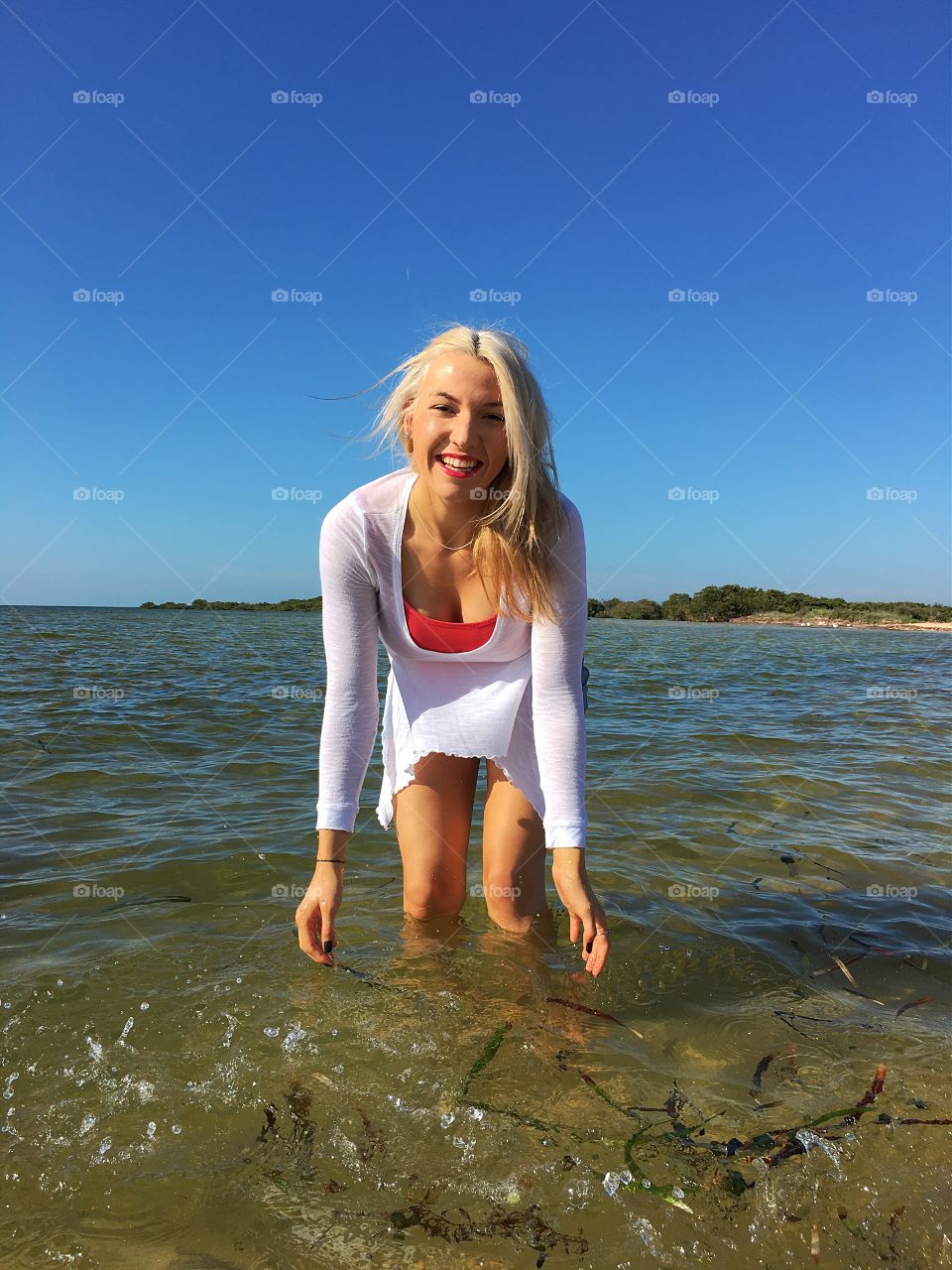 Young happy woman enjoying in sea