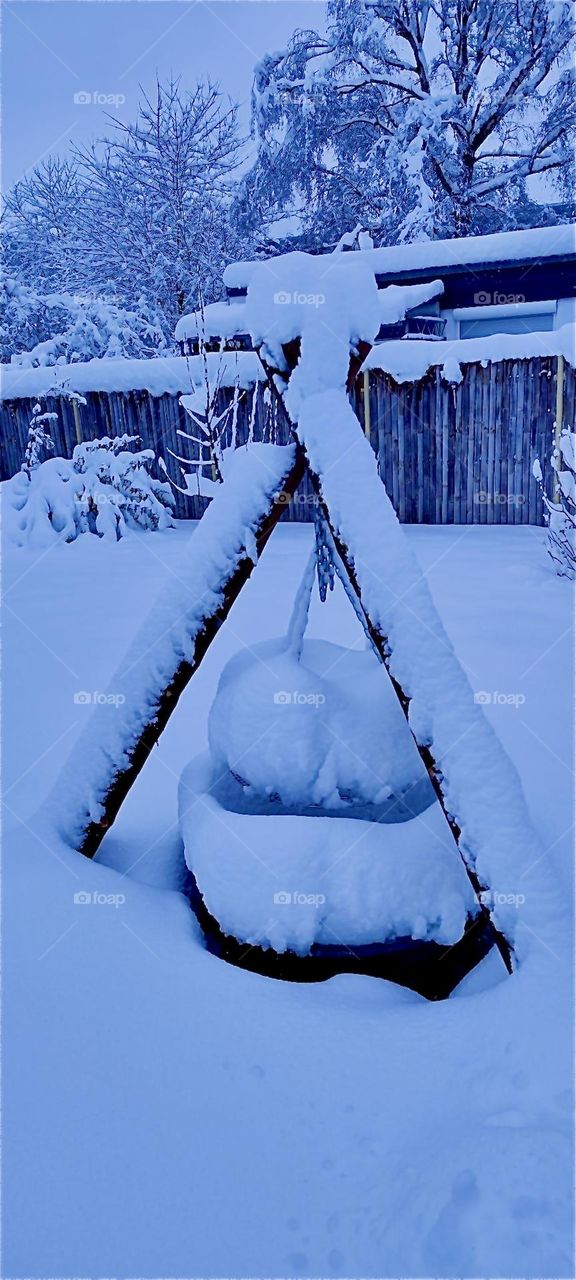 This barbecue grill in a garden in „Bavaria“, Germany is now hopelessly covered in heaps and heaps of snow. No barbecues are planned here anytime soon. Got to wait until the snow melts come spring next year. 2023. Hypnotic Productions