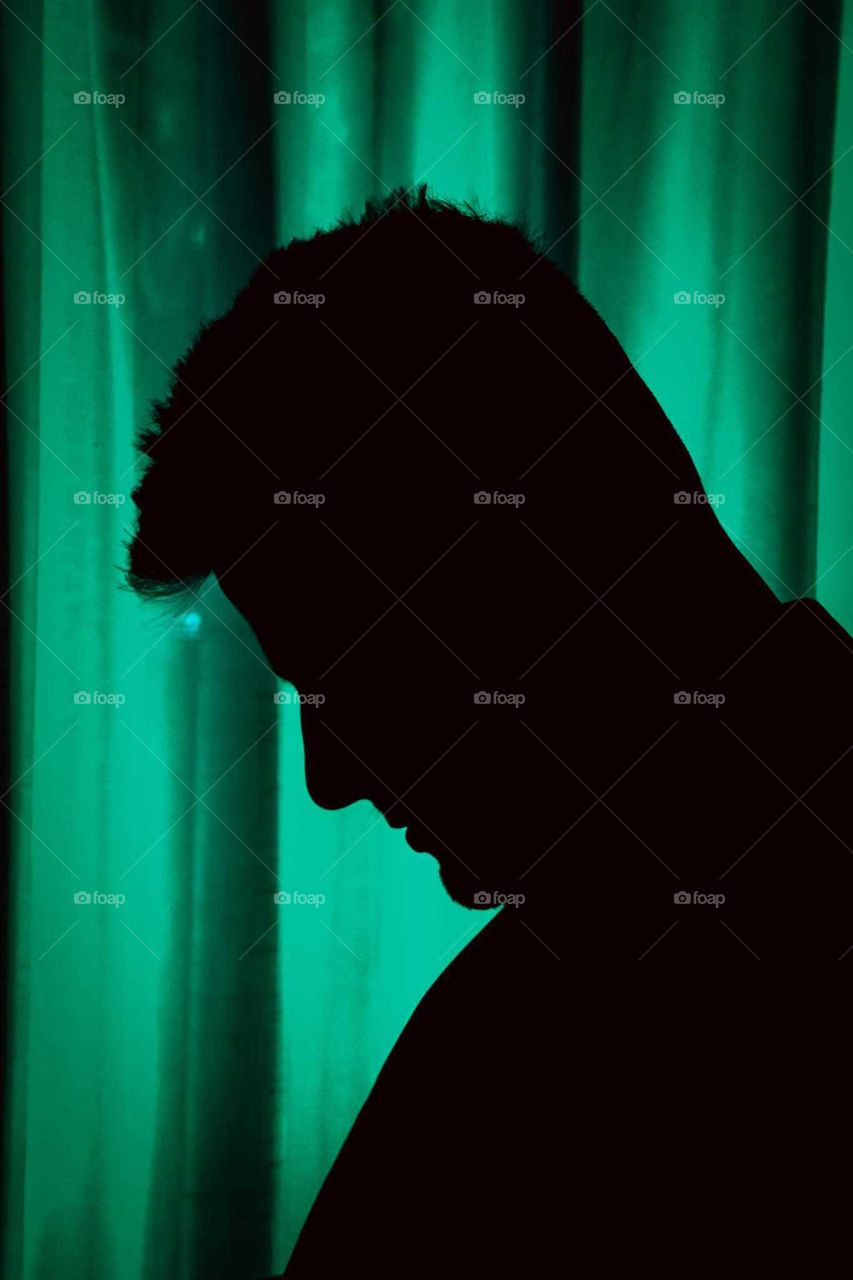 green silhouette of a man. misterious magician