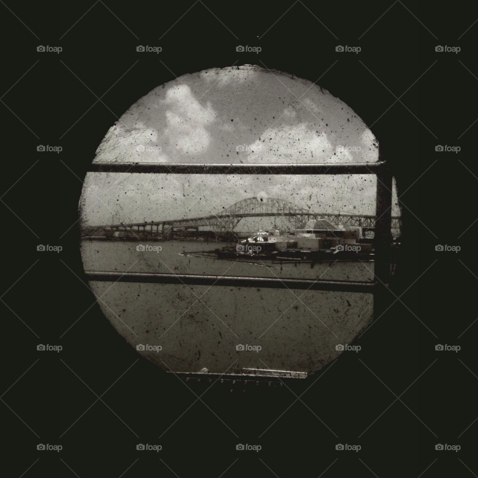 A porthole giving vision to the beautiful port of Galveston, Texas; A historical view of the city. 