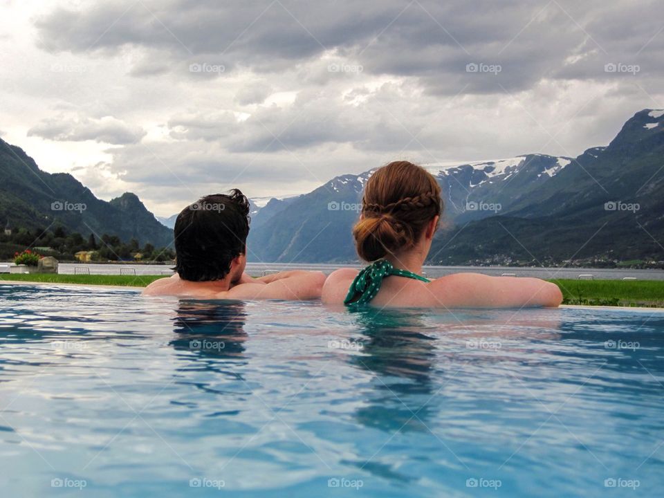 Rear view of a couple in pool