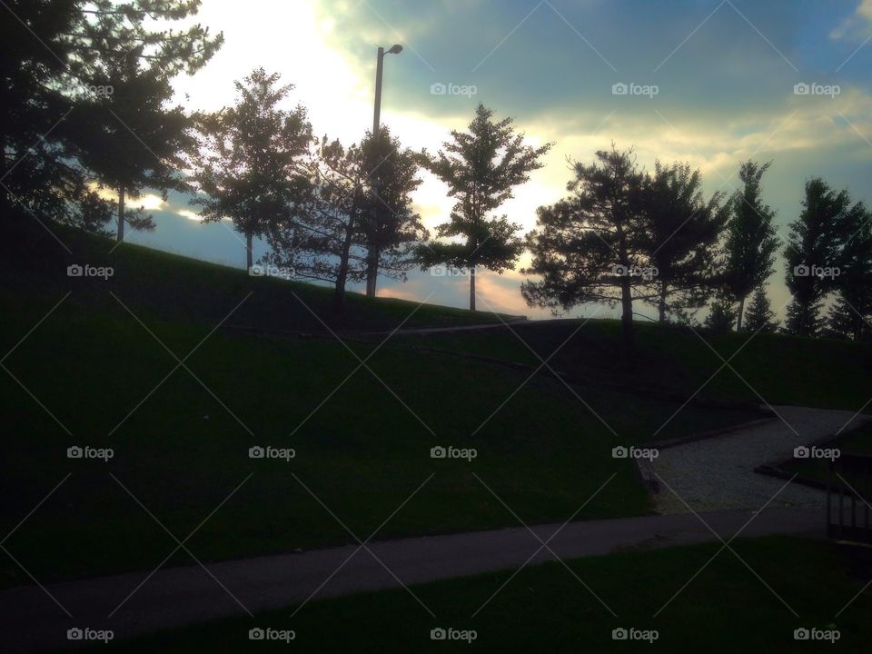 Sunset on a hill. Walking path leading to sunset 