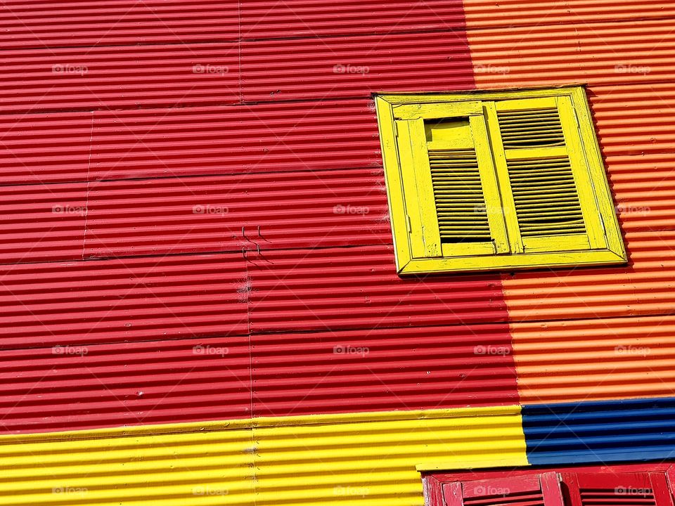 yellow window on a red wall