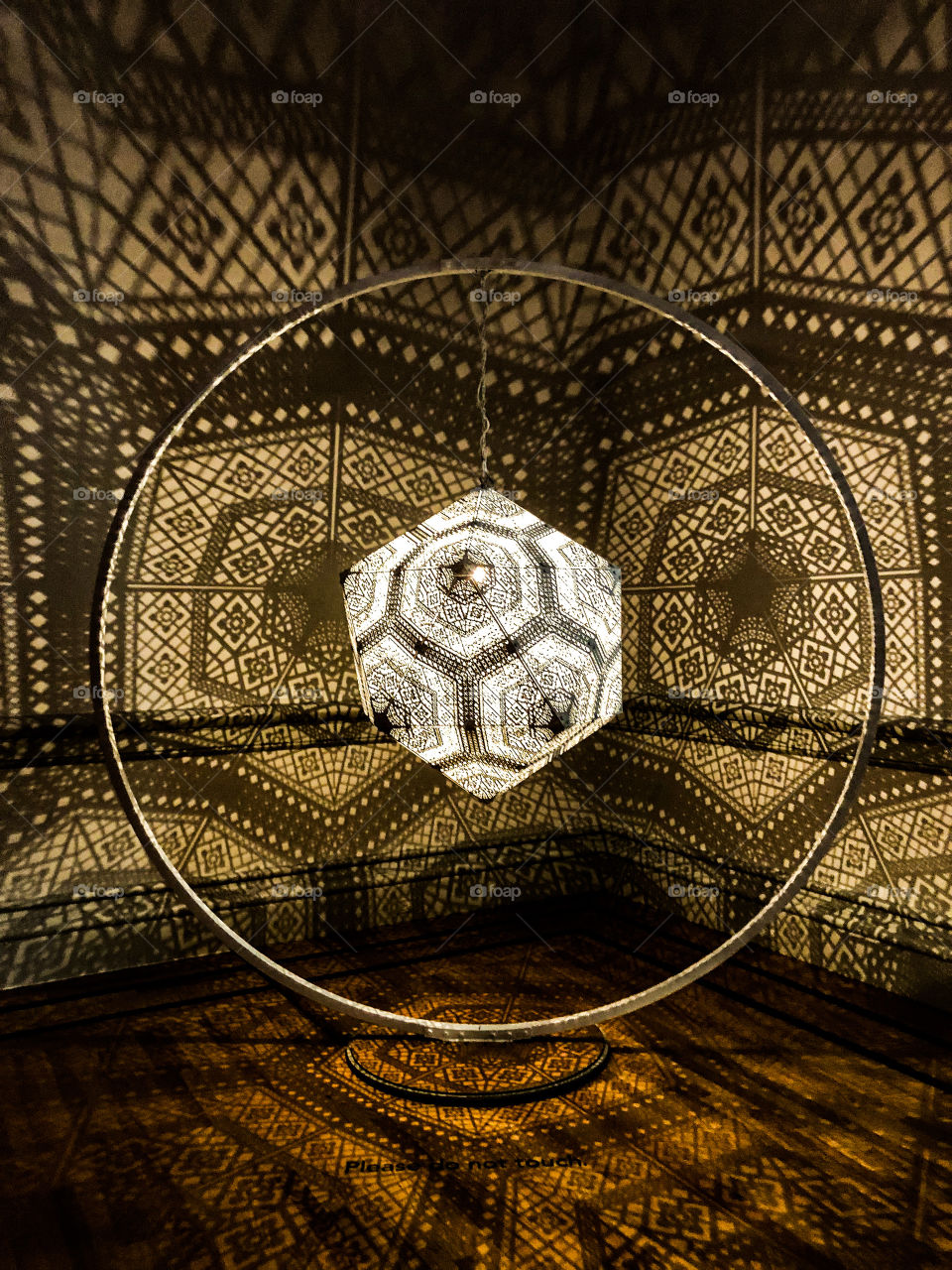An artistic light sphere casts geometric shapes on the walls at the Renwick Gallery in Washington DC