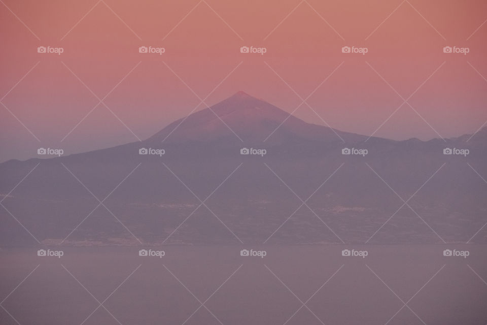 Amazing sunset. View of Tenerife volcano from the island of La Gomera, Canary Islands, Spain.