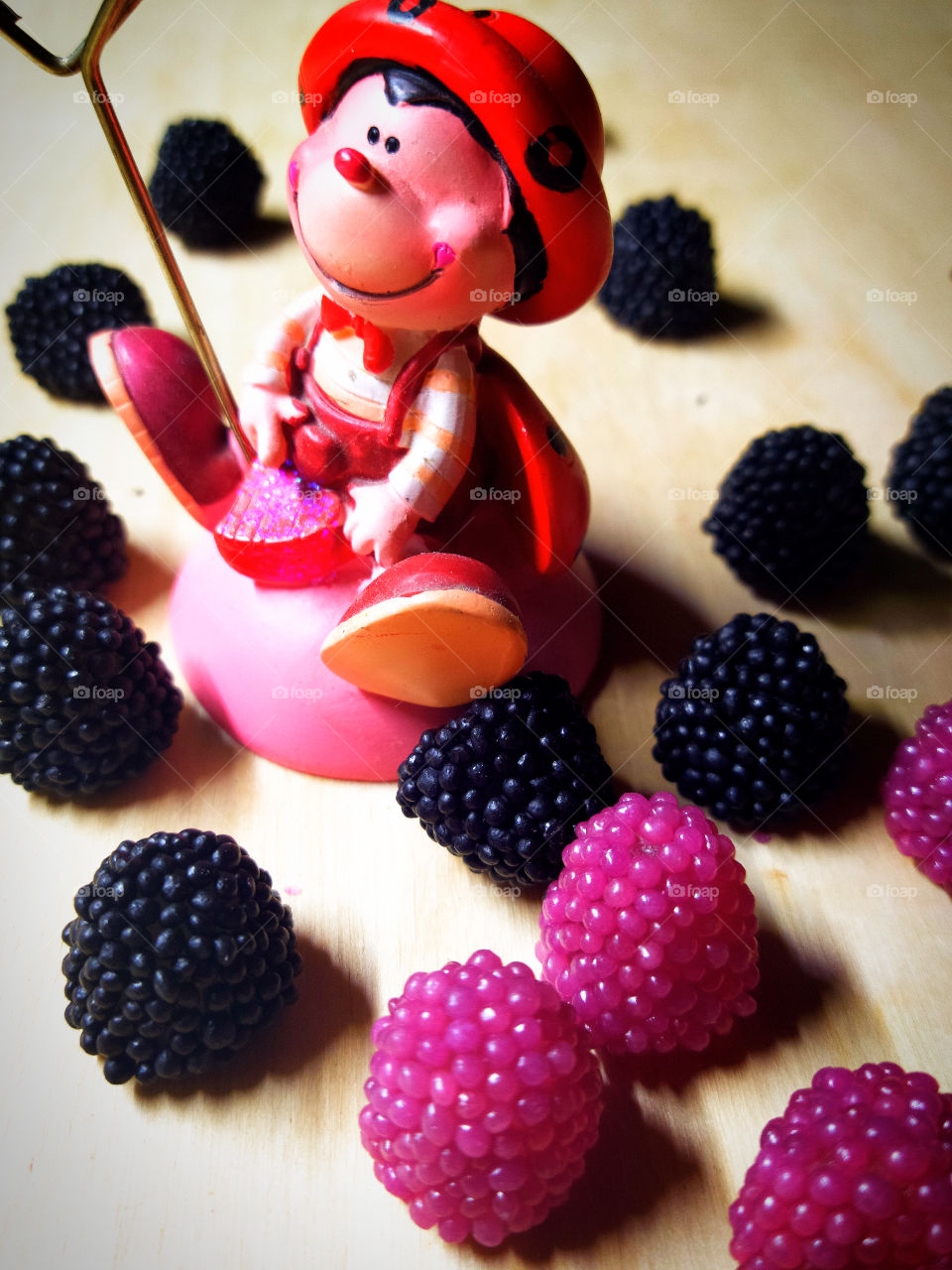 Toy "funny bee" and black and red blackberries