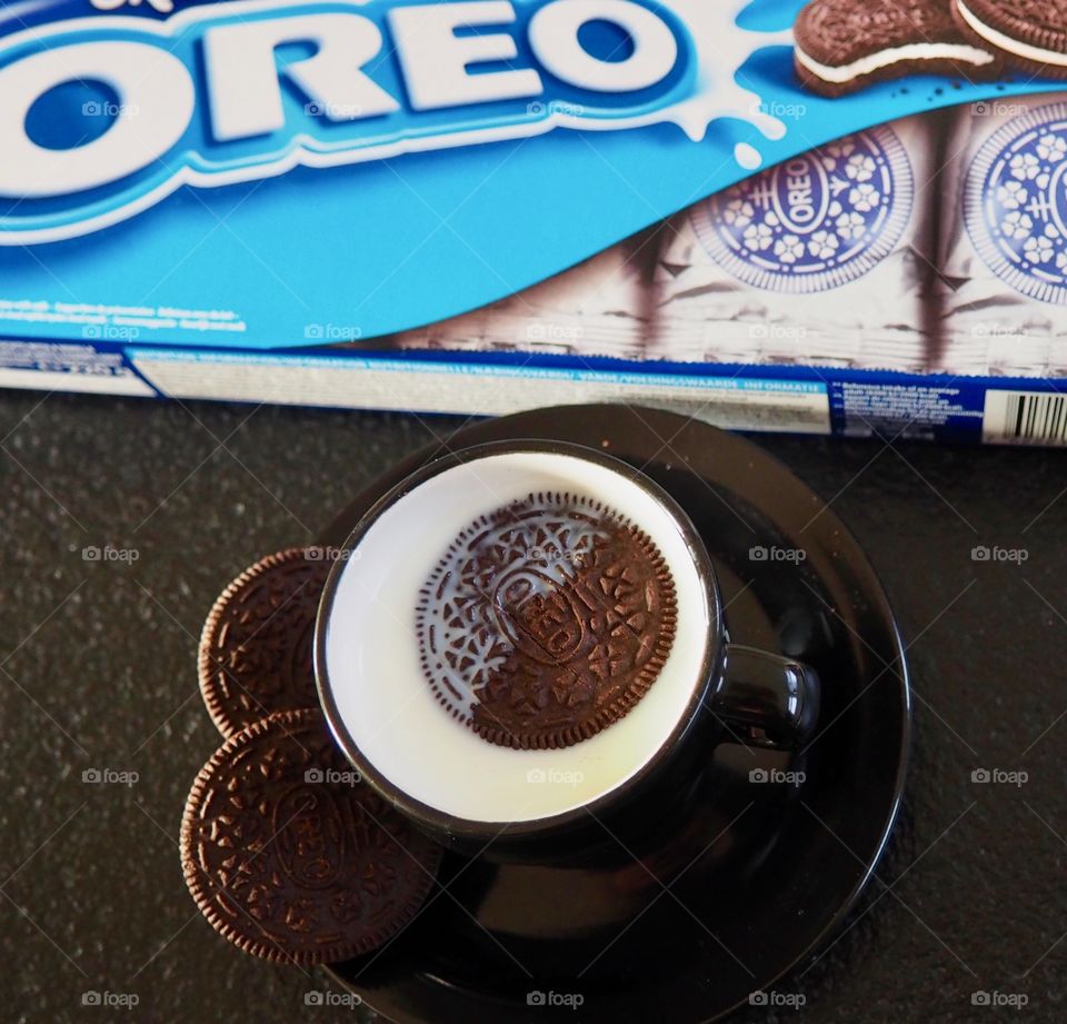 Oreo cookies with a cup of milk and package.