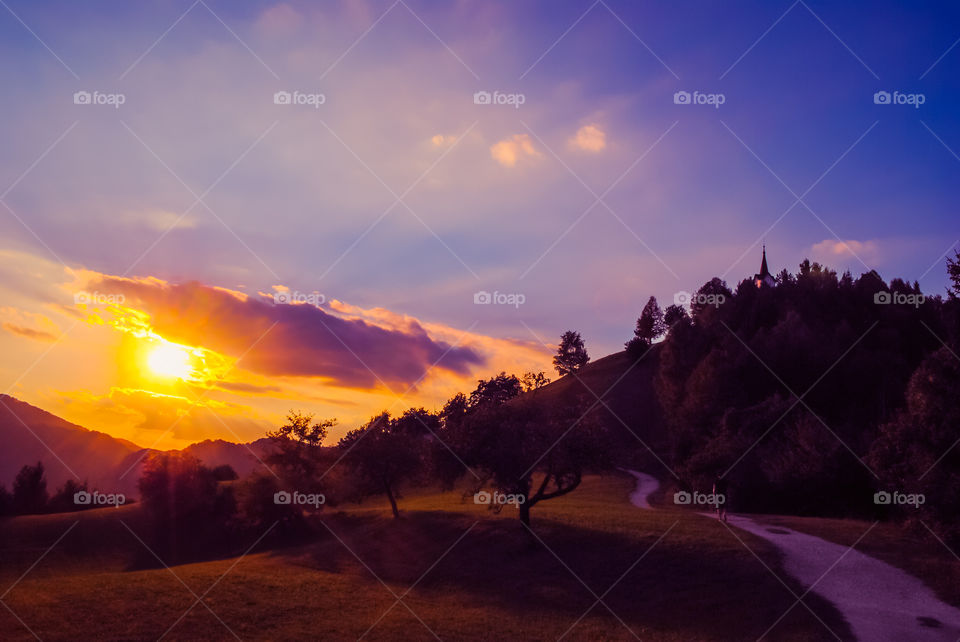 Hiking during sunset hour. Hiking up hill to beautiful church up on hill to see amazing sunset at golden hour 