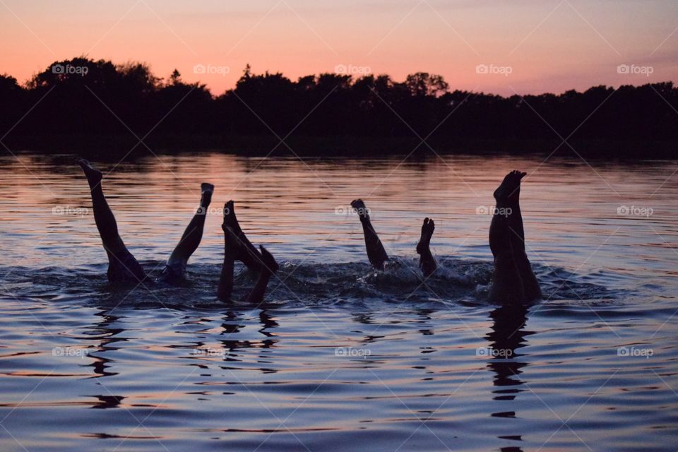 Silhouette of human leg in the lake