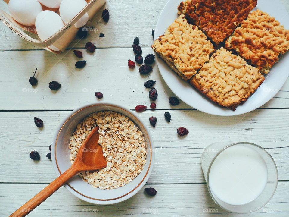 home-made cake, oatmeal, eggs and a glass of milk