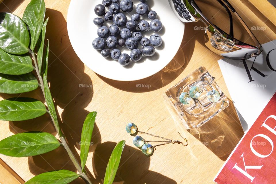 Fresh, appetizing blueberries on a white plate with holiday and summer items.