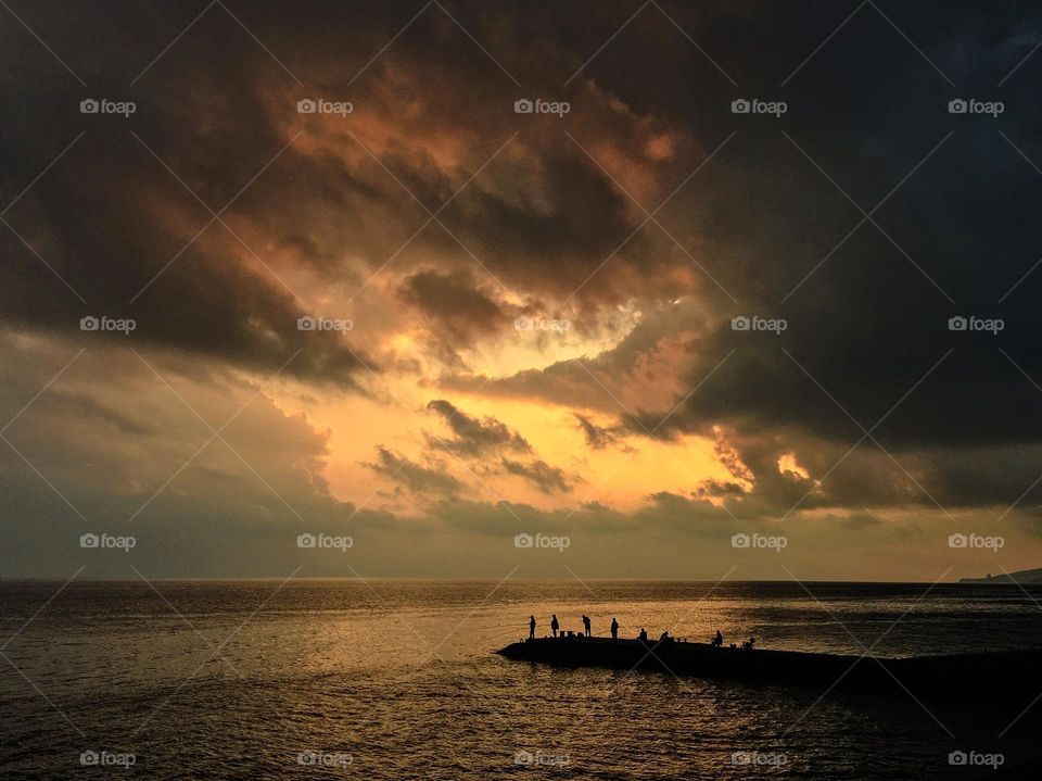 Fishermen fishing enjoying sunset. Crimea, Ukraine. 