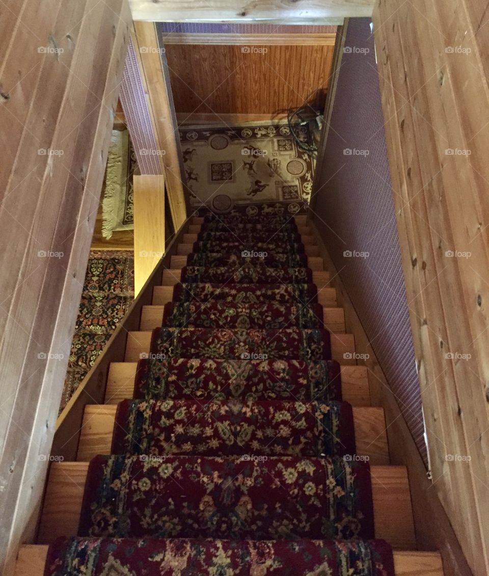 Staircase with a traditional red rug