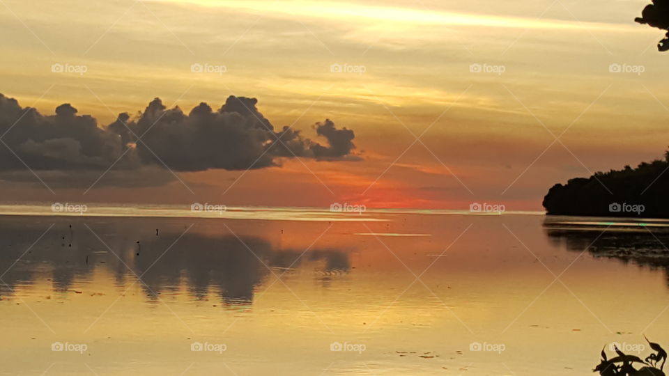 Clouds reflected on water with dramatic sky