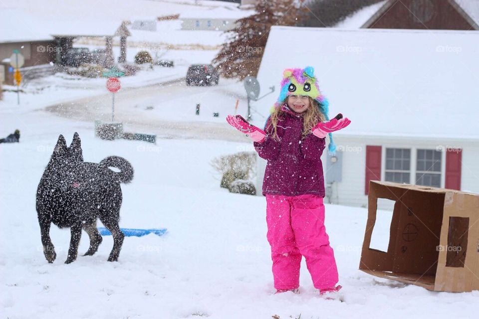 Girl and dog in snow