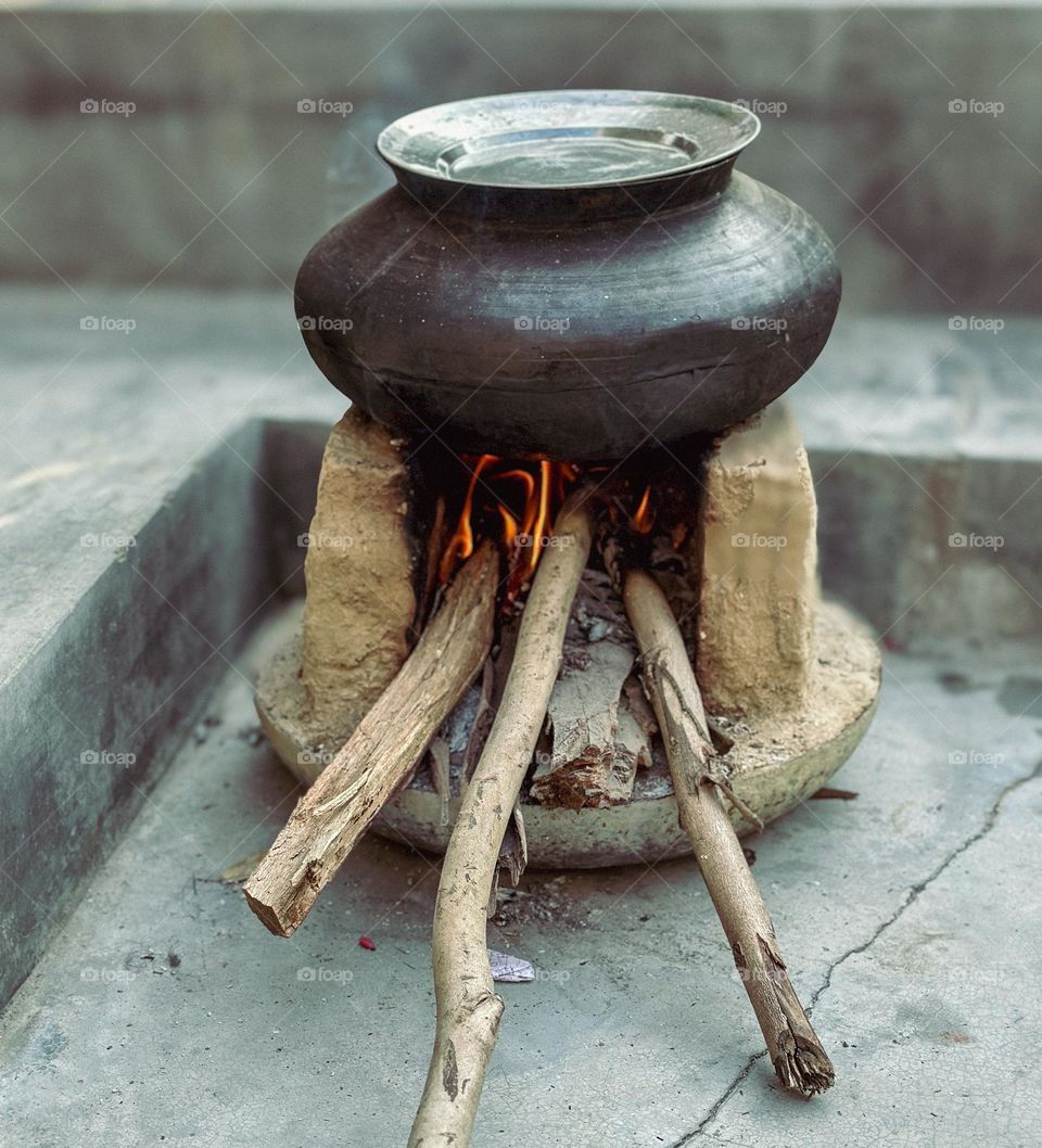 Vintage cooking utensil on a old style chulha 