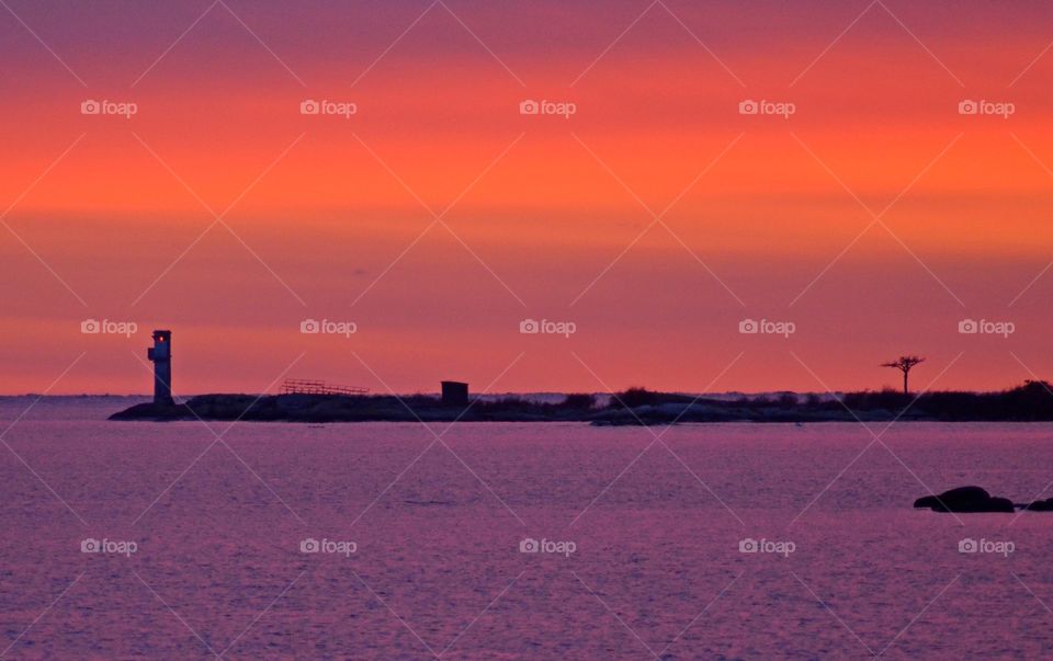 Idyllic sea and lighthouse against dramatic sky