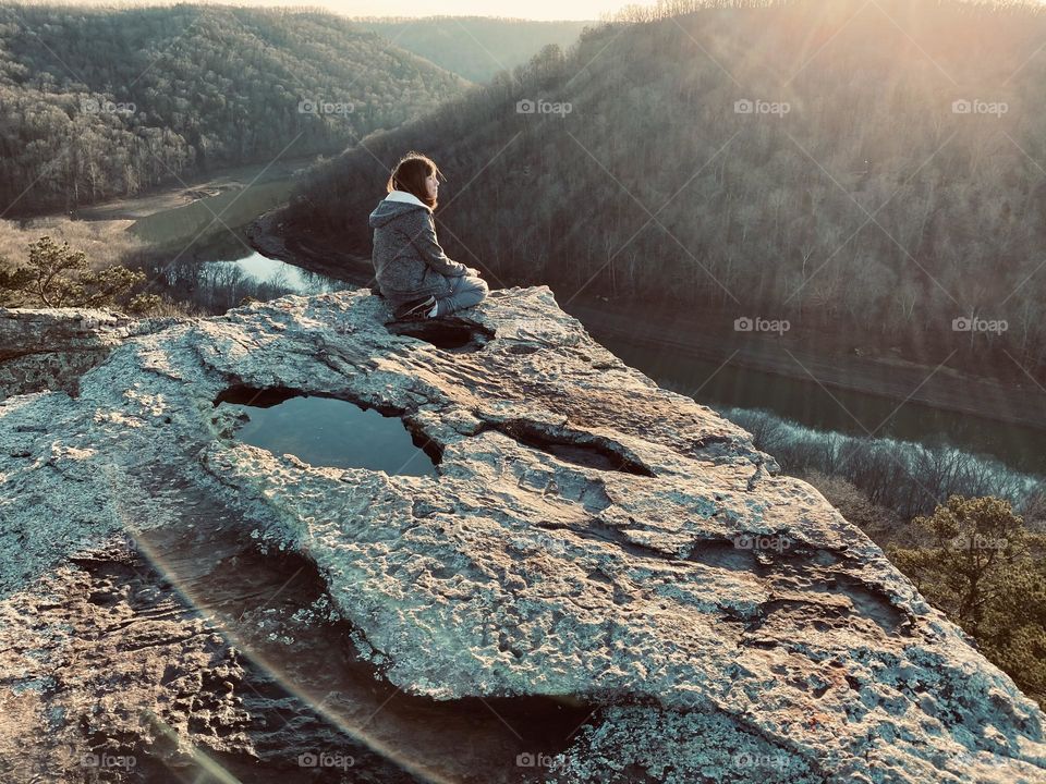 A teenager looking out over the south fork of Lake Cumberland in winter 