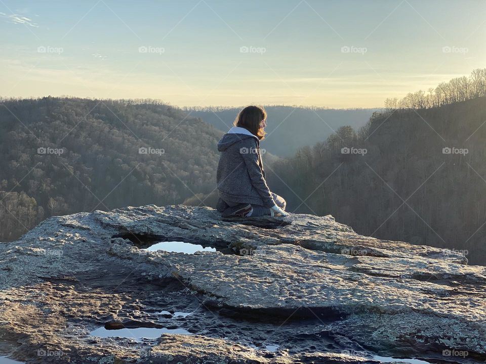 Teenager finding peace while looking out at the hills of Kentucky 