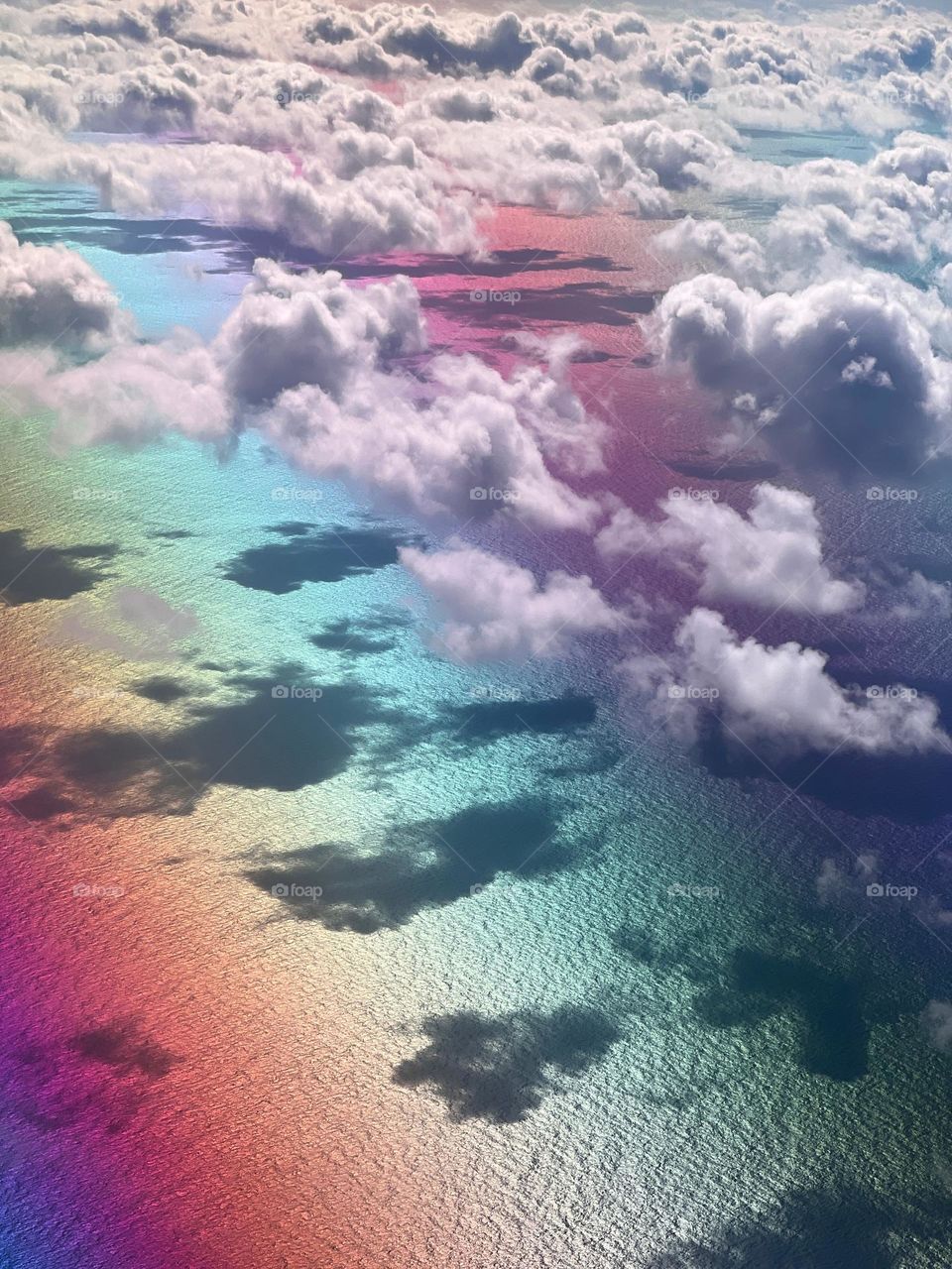 Aerial view of the clouds over colorful ocean