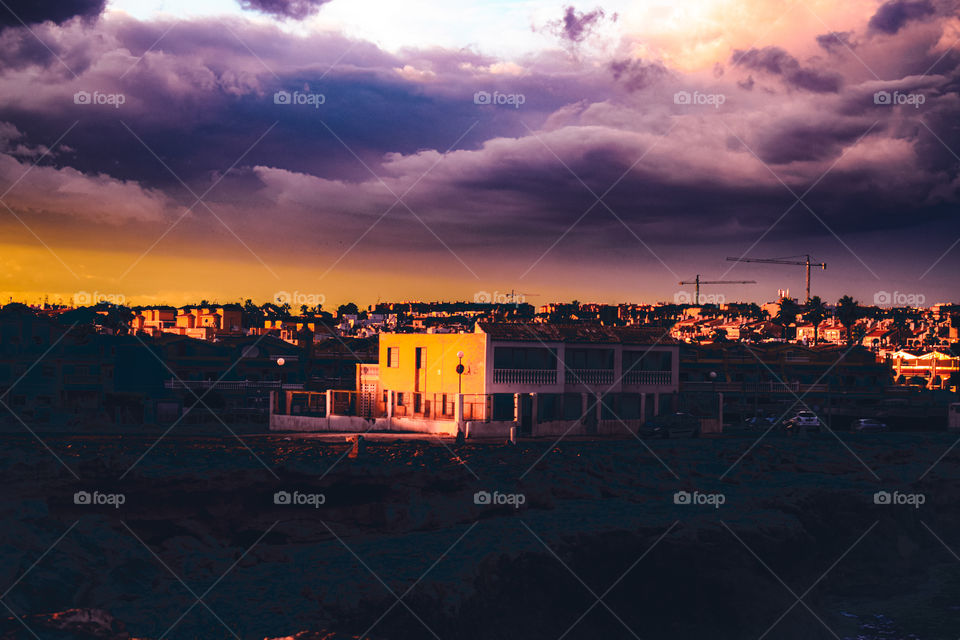 Dramatic sunset with buildings in a Spanish town