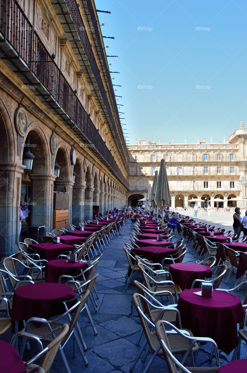 People relaxing at a street café in Plaza Mayor of Salamanca, Spain.