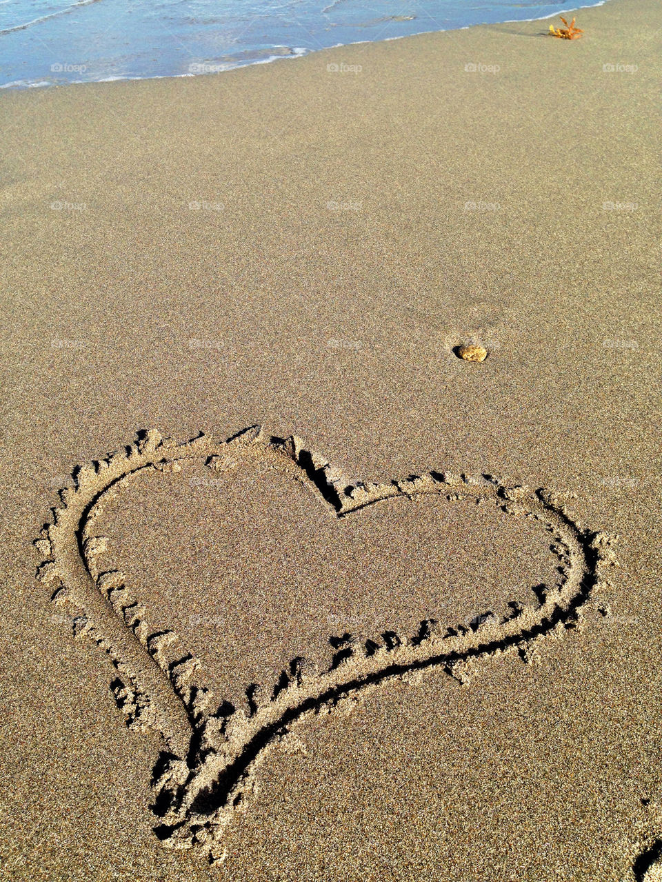 Heart drawn on sand at beach, Florida, USA