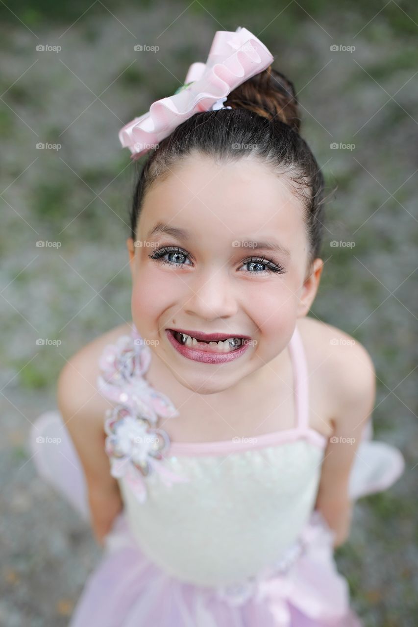 Little girl outside smiling before ballet recital
