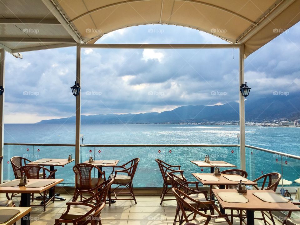 Empty summer restaurant near the sea in Greece on a cloudy day